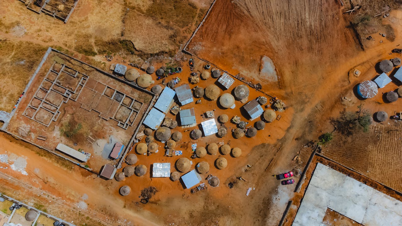 Aerial view of traditional huts and structures in Abuja, showcasing rural Nigerian architecture.